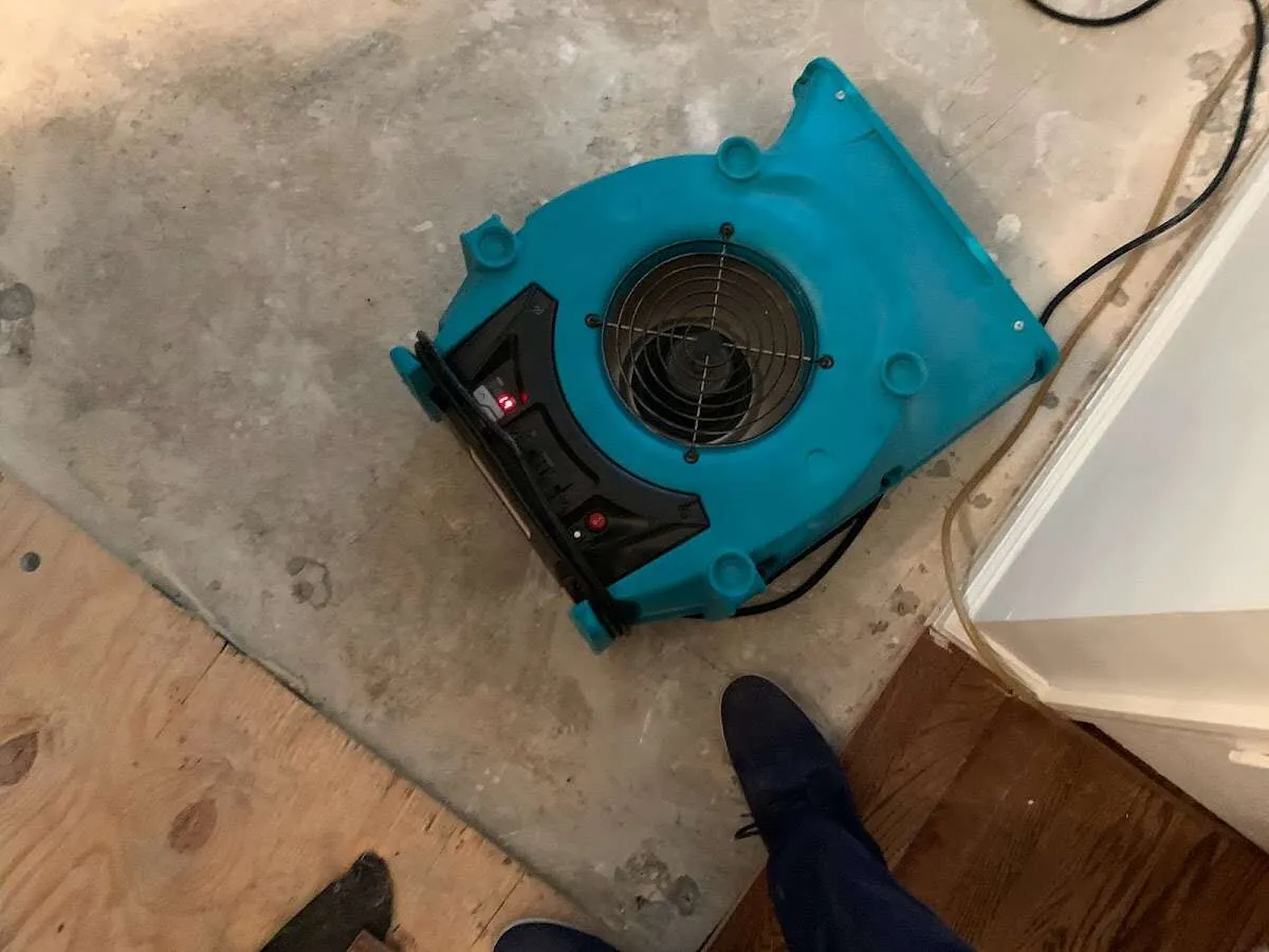 Air mover drying subfloor during Commercial Water Damage Restoration in Prairie Ridge